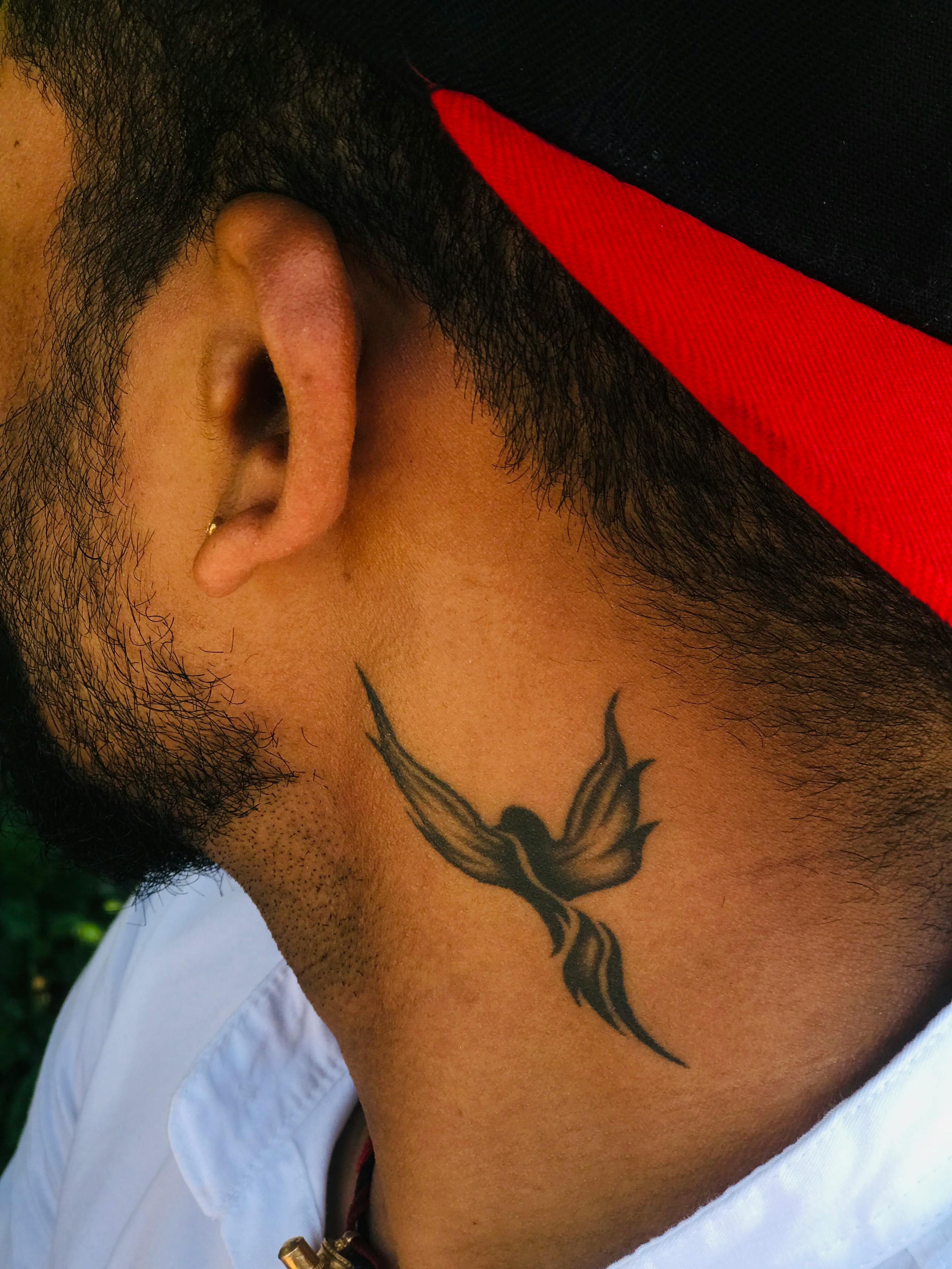 Neck tattoo of a phoenix rising from ashes on Craiyon